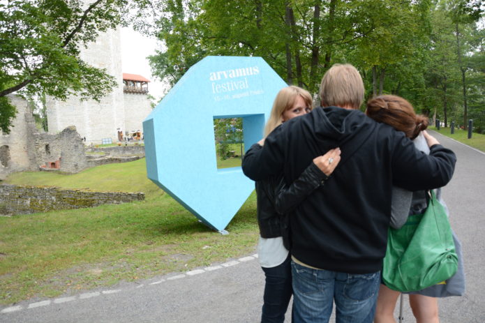 People hugging in front of the Arvamusfestival sign